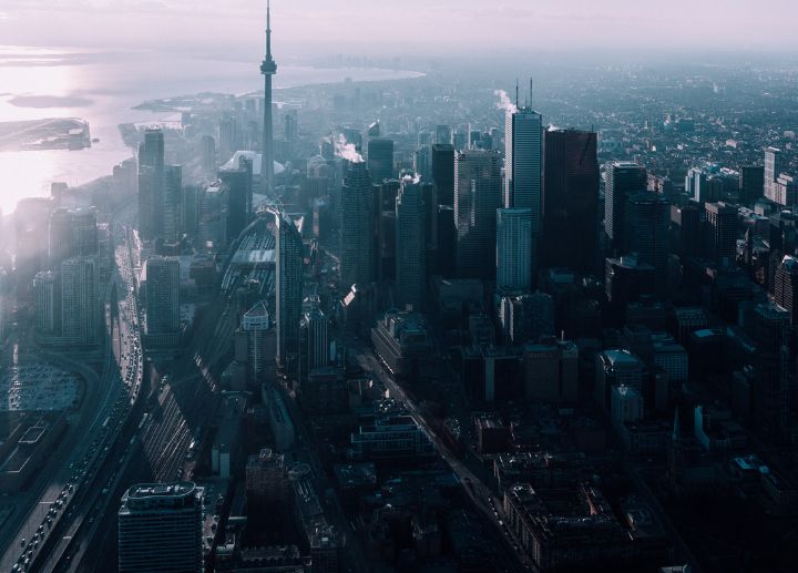 Aerial view of Toronto's city skyline with tall buildings near a waterfront